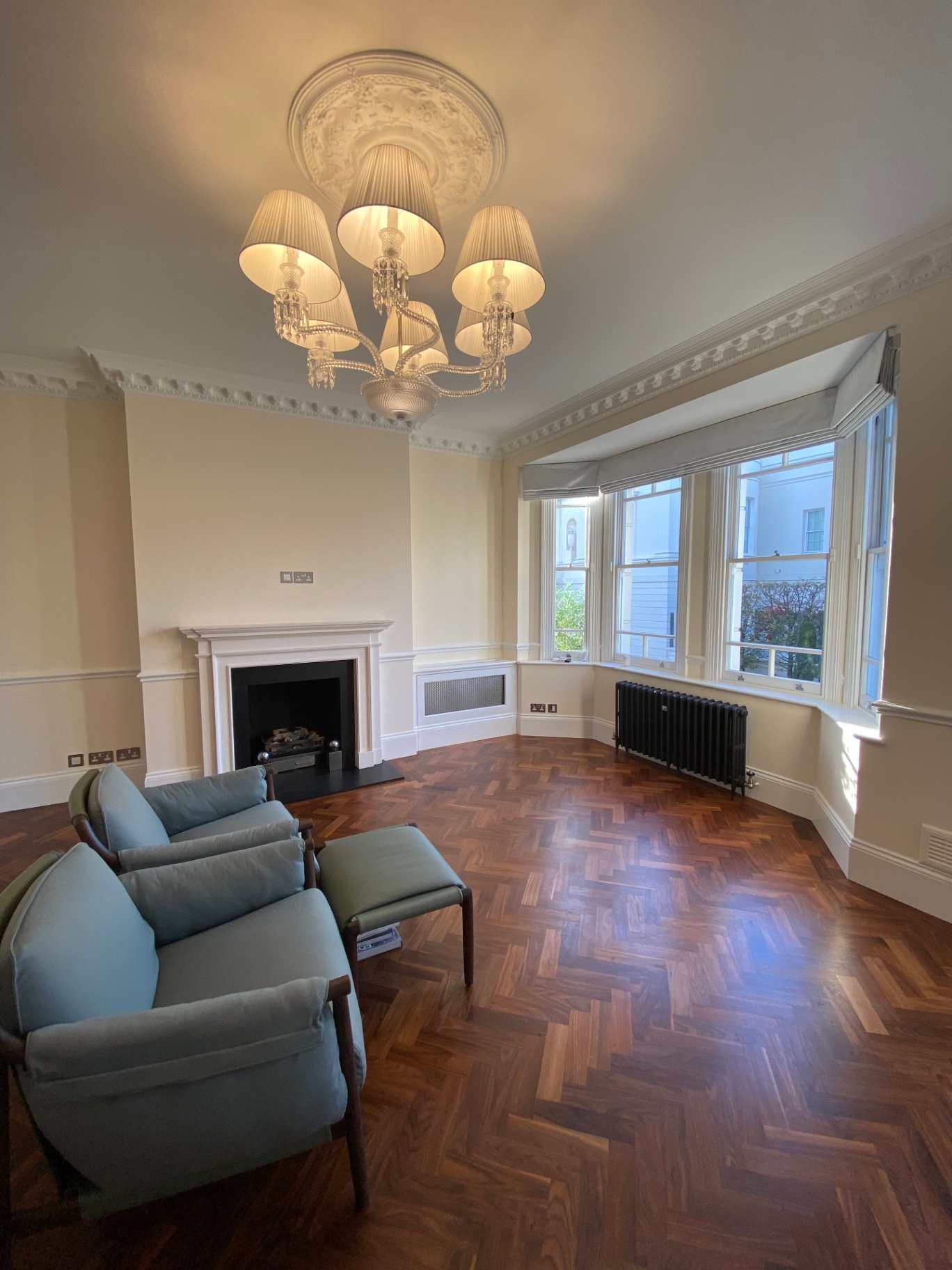 After photo — Belgravia period restoration in farrow & ball tallow 203. Drawing room and garden-level room repainted, with original cornicing and ceiling rose hand-cut.