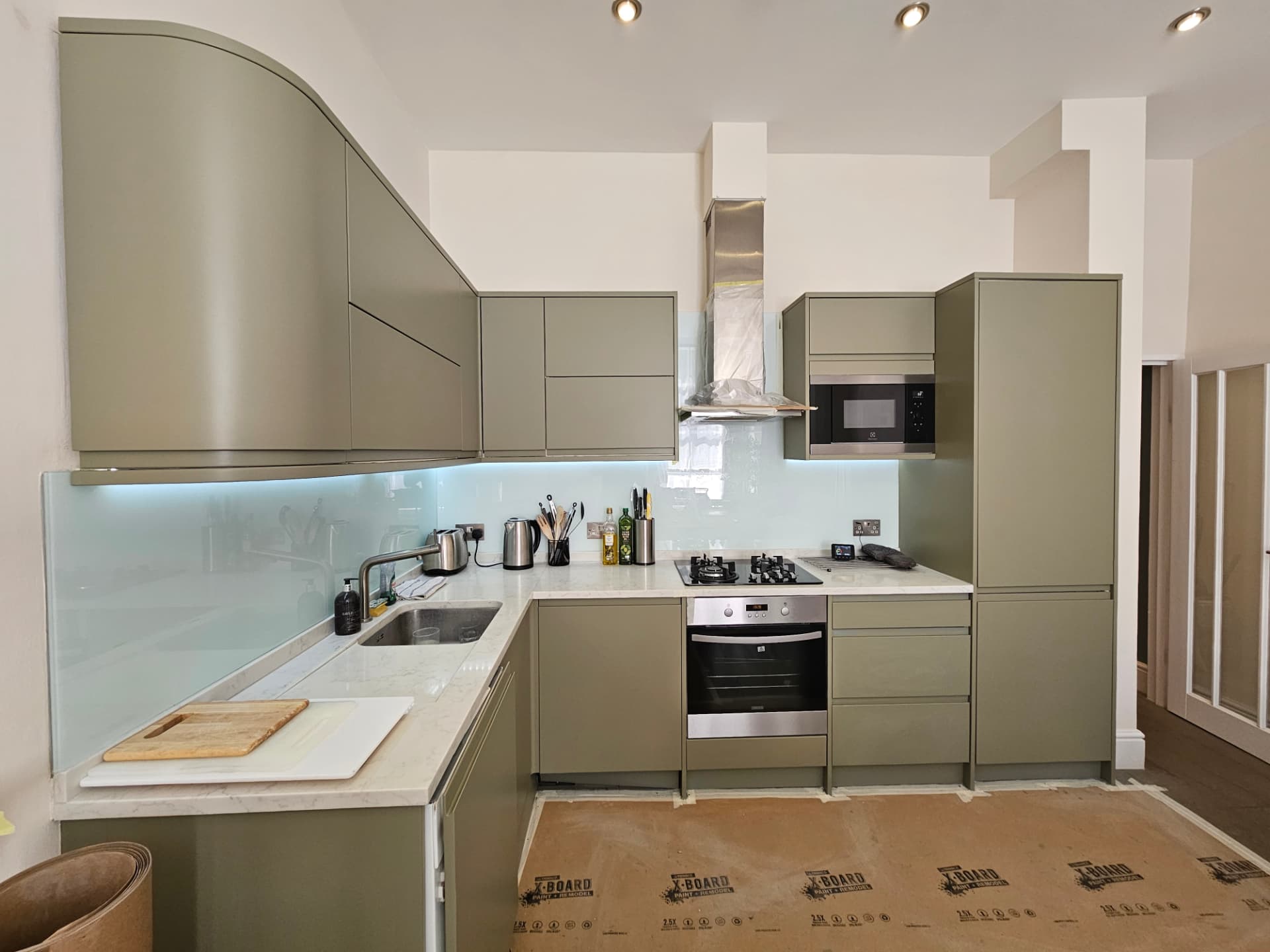 After photo — Maida Vale kitchen transformation in farrow & ball treron. Hand-finished kitchen respray in a fine low-sheen matt for a factory-flat, hard-wearing finish.